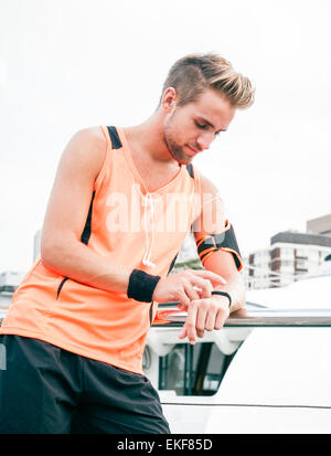 Young attractive guy using wearable fitness gear Stock Photo