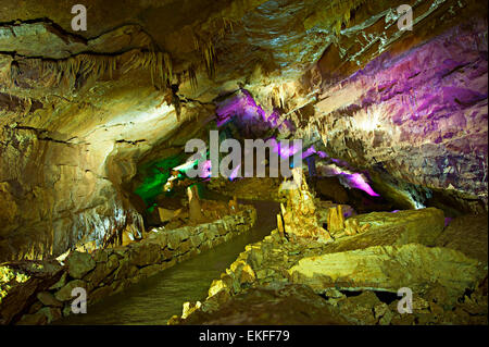 Inside the Sataplia cave in Georgia illuminated by colorful lights Stock Photo