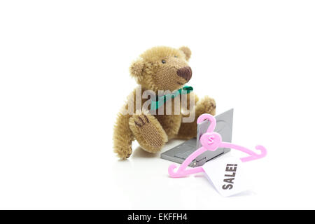 teddy bear,hanger with a price tag sale and miniature laptop  is Stock Photo