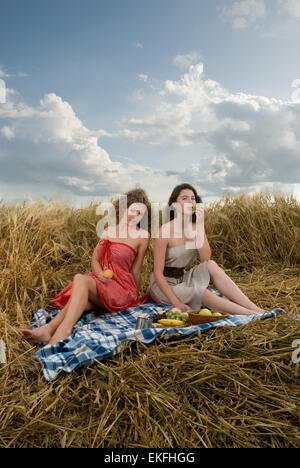 Two beautiful slavonic girls on picnic in wheat field Stock Photo - Alamy