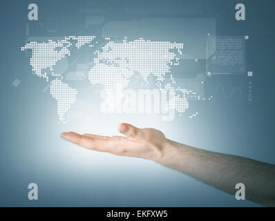 mans hand showing world map Stock Photo