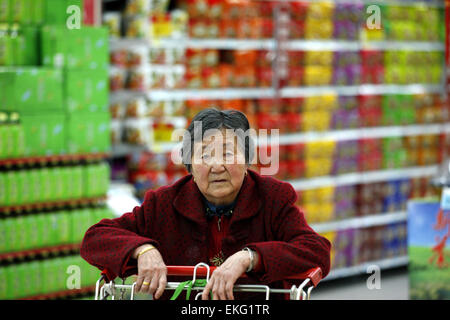 A Chinese costumer visit a supermarket at  a market  in Huaibei city, Anhui province, east China on 10th April 2015.China’s consumer price index (CPI) rose 1.4 per cent year-on-year in March, slightly more than expectations.The rise in the CPI followed a 1.4 percent rise in February, according to figures provided by the National Bureau of Statistics on Friday. Stock Photo