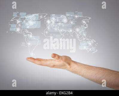 mans hand showing world map Stock Photo
