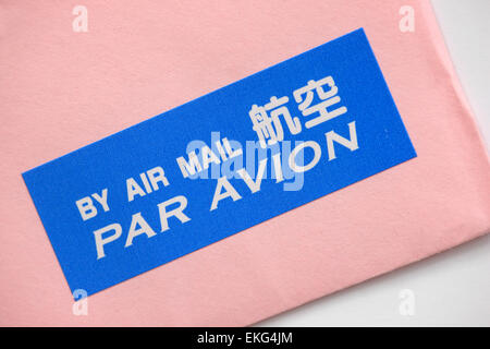 By Air Mail par avion label on a pink envelope Stock Photo