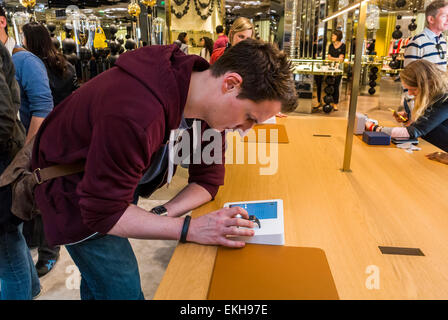 Paris, France. apple showroom in French Department Store, Galeries Lafayette for I-Watch Customers Trying New Products, shopper choosing goods, apple customer, teenagers accessories Stock Photo