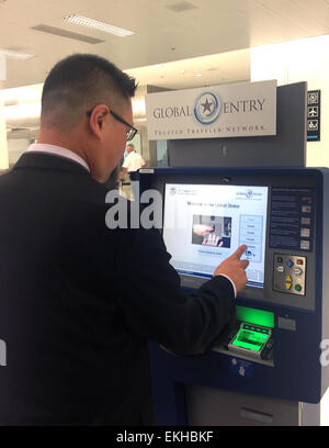 041813:  An individual uses the Global Entry kiosk at Miami's International Airport.  Global Entry is a U.S. Customs and Border Protection (CBP) program that allows expedited clearance for pre-approved, low-risk travelers upon arrival in the United States.  Larry Panetta Stock Photo