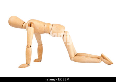Wooden dummy doing push ups isolated on a white background Stock Photo