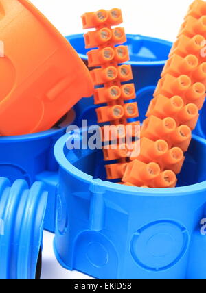 Orange and blue electrical boxes and components for use in electrical installations, accessories for engineering jobs Stock Photo