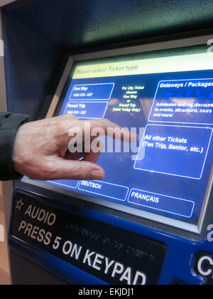 Man Purchasing Metro North Transit Train Tickets at Self Serve Vending Machine, Grand Central Terminal, NYC Stock Photo