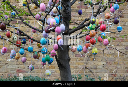 colourful easter eggs hanging from tree branches, city of london, england Stock Photo