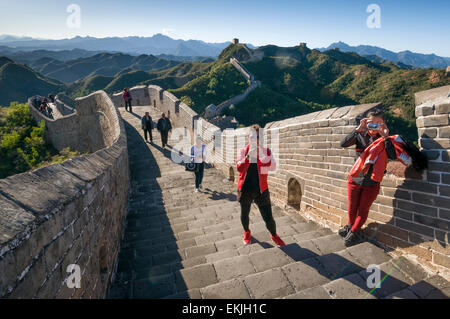 Chinese tourists snap photos as the Great Wall meanders the mountain tops in the Jinshanling section, Heibei Province, outisdeBe Stock Photo