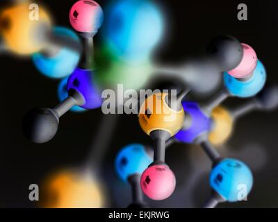 Ball and stick molecular model with chemical formula written on glass ...