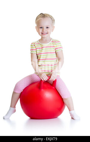 happy little girl jumping on bouncing ball Stock Photo