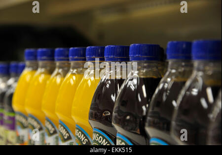 Rows of plastic bottles soft drinks various brands Coke Pepsi coca cola ...