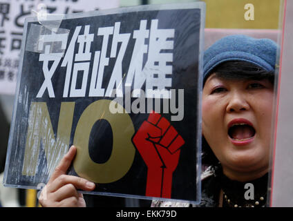 Tokyo, Japan. 11th Apr, 2015. A woman holds a placard during a demonstration to protest against the revision of the pacifist Article 9 of the Japanese Constitution in Tokyo, Japan, April 11, 2015. Some 30 people participated in this protest. Credit:  Stringer/Xinhua/Alamy Live News Stock Photo