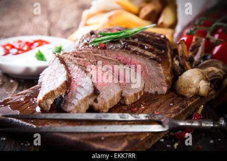 Delicious beef steak on wooden table, close-up Stock Photo