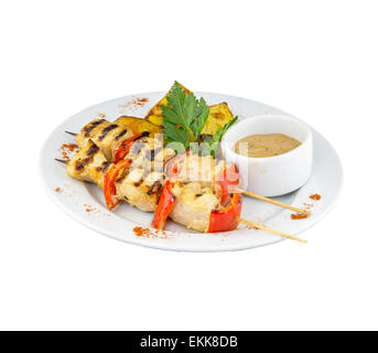Chicken skewers with potatoes and sauce on isolated background Stock Photo