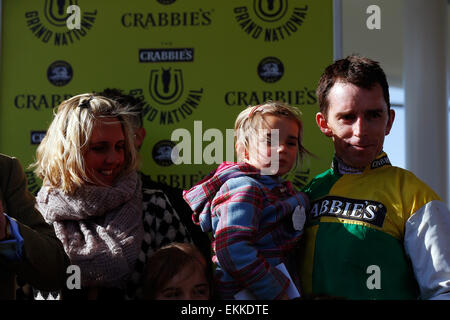 Aintree Racecourse, Liverpool, UK. 11th Apr, 2015. Crabbies Grand National. Winning jockey Leighton Aspell with his wife and daughter Credit:  Action Plus Sports Images/Alamy Live News Stock Photo
