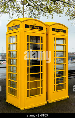 Telephone boxes in Guernsey, Channel Islands, are yellow unlike the rest of the United Kingdom Stock Photo