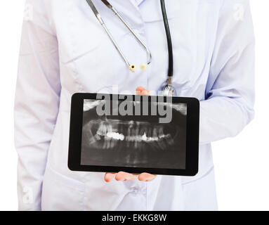 nurse holds tablet pc with X-ray picture of human jaws with dental crown screen isolated on white background Stock Photo