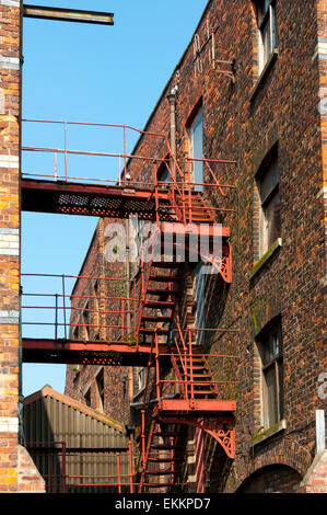 Fire escape staircase on an old warehouse building, Ancoats, Manchester, England, UK. Known as the German Warehouse. Stock Photo