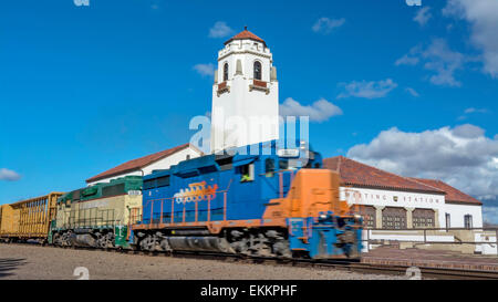 Train rolls by Depot in Idaho Stock Photo