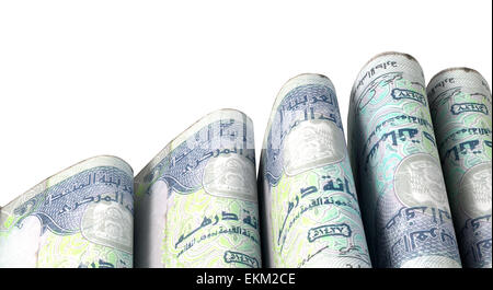 A close-up view of five wads of folded over stacks of dirham banknotes each bound infomally by a rubber band set out in a domino Stock Photo