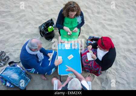 Saturday 11th, April 2015, Las Palmas, Gran Canaria, Canary Islands, Spain. Weather:  Locals playing cards at sunset on Las Canteras beach in Las Palmas, the capital of Gran Canaria Stock Photo