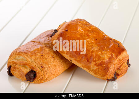 Two sweet rolls with chocolate  on  a wooden plate, Stock Photo