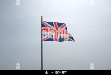 Union Flag flying against a white background sky Stock Photo