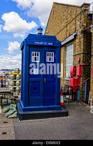 An old fashioned rectangular blue police box standing in front of the ...