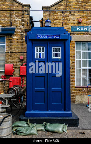 An old fashioned rectangular blue police box standing in front of the ...