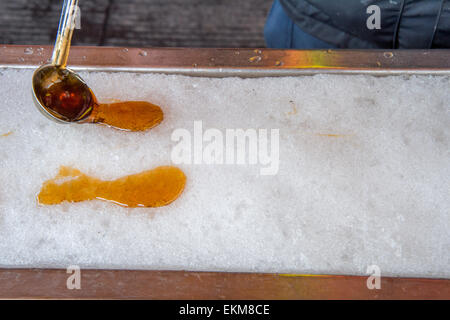 Maple taffy on snow during sugar shack period. In Quebec, Canada. Stock Photo