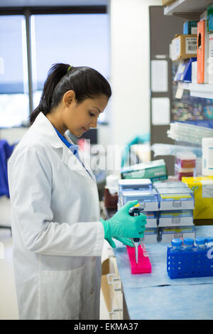 Closeup portrait, young scientist in labcoat doing experiments in lab, academic sector. Stock Photo