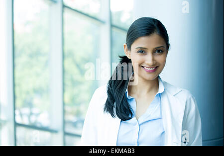 Closeup head shot portrait of friendly, cheerful, smiling confident female, healthcare professional with lab coat. Stock Photo