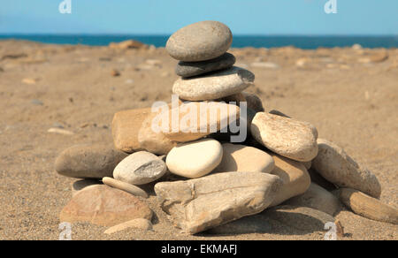 Stacked stones on Geropotamos beach with view on the Mediterranean Sea, Rethymno region, Crete, Greece. Stock Photo