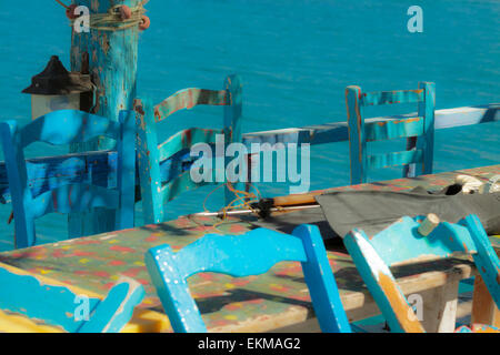 Mediterranean mood and typically Greek blue chairs in Matala, situated on the Bay of Messara, Heraklion region, Crete, Greece. Stock Photo