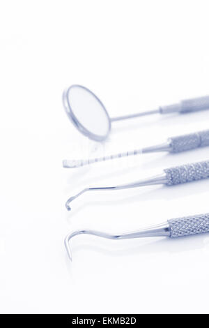 Periodontal probes or dental tools and mirror with selective focus on the front dental explorer or sickle probe Stock Photo