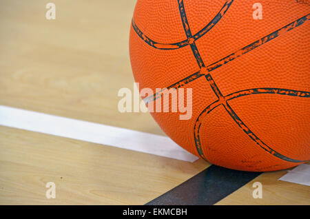 Close up of a basketball on boundary line on a basketball court Stock Photo