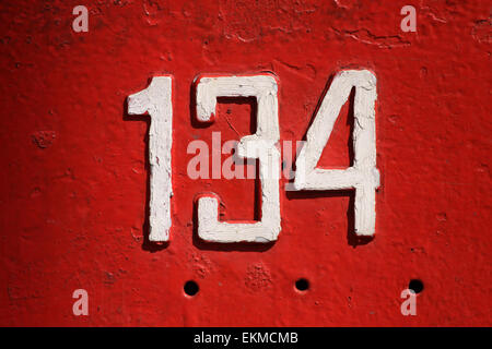 Vintage metal house number on the wall, retro house number Stock Photo