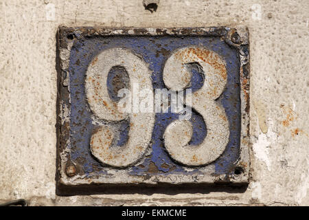 Vintage metal house number on the wall, retro house number Stock Photo
