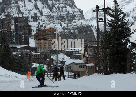 tourist skiing down snow coved path ski resort Stock Photo