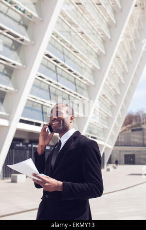 black businessman have phone conversation outdoors Stock Photo