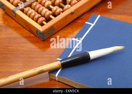 chinese book , abacus and writing brush Stock Photo