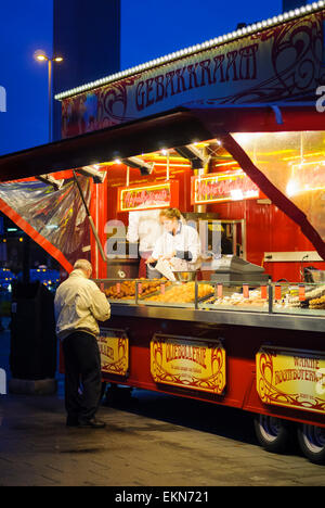 Snack stall at Amsterdam's Schiphol Airport, Holland, selling traditional Dutch food including waffles and pastries, in the evening. Food stand. Stock Photo