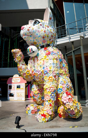 Large, colourful beckoning cat statue, similar to a maneki-neko, Siam Square, Bangkok, Thailand; big quirky Thai beckoning cat; good luck symbol; Stock Photo