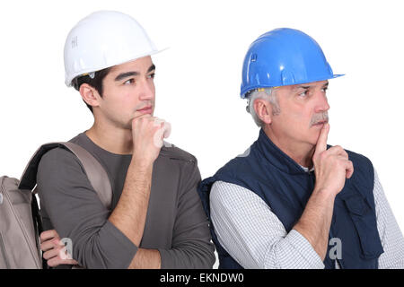 Young intern copying master's body  language Stock Photo