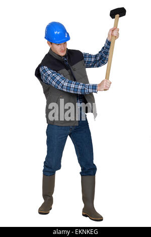 Builder using sledge-hammer Stock Photo