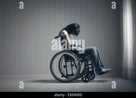 Crying woman sitting in wheelchair Stock Photo