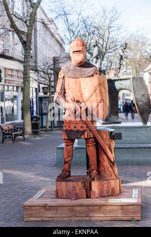 Northampton, UK. 13th April, 2015. 'A Knight's Trail' features six large-scale Medieval knight sculptures around the Town Centre, depicting the historical details of the English knights from the 13th, 14th and 15th centuries. All the sculptures of the knights have been carved from huge trunks by a group of three chainsaw artists, Daniel Cordell, Simon O'Rourke and Hue Thomas, who have exhibited around the world and won a number of prestigious commissions, including ones at Hyde Park, Kensington Gardens and more. Credit:  Keith J Smith./Alamy Live News Stock Photo